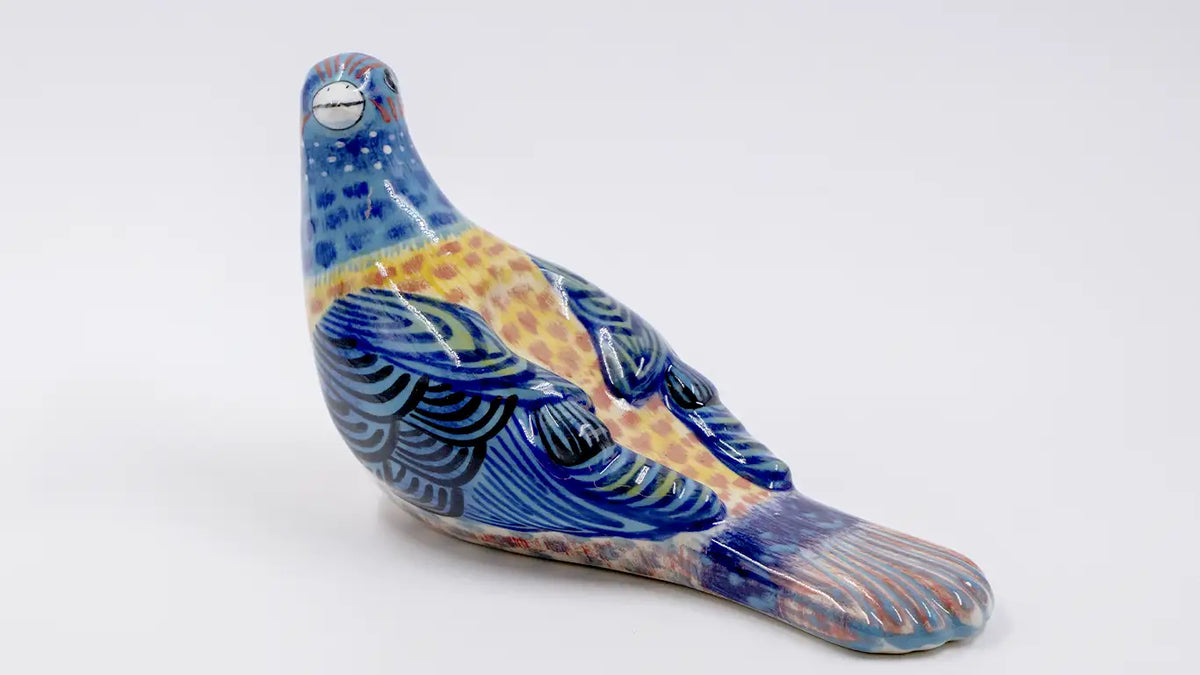Pájaro picotero azul de cerámica